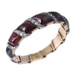 A mid 19th century garnet and diamond bangle