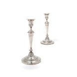 A pair of George III silver circular candlesticks by John Green, Roberts, Mosley & Co.