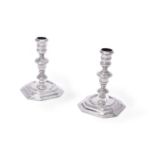 A matched pair of cast Britannia standard silver candlesticks