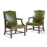 A pair of mahogany and brass studded green leather upholstered armchairs, in George III style, 19th