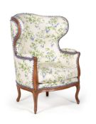 A Louis XVI walnut and upholstered wing armchair, late 18th century