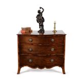 A George III mahogany and goncalo alves serpentine chest of drawers, circa 1790
