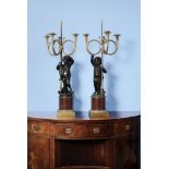 A pair of French gilt and patinated bronze, and rouge griotte mounted figural three light candelabra