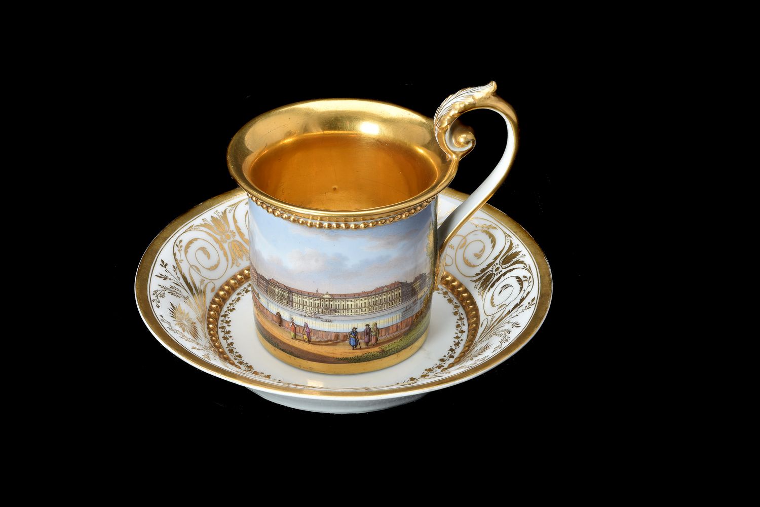 A Meissen Empire style topographical cabinet cup and saucer painted with a view of the Winter Palace