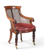 A George IV mahogany bergere library armchair, circa 1825, in the manner of Gillows