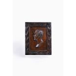 A stained hardwood, probably elm, commemorative portrait relief panel of Field Marshal Sir Arthur We