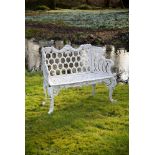 A white painted cast iron 'rose garden pattern' garden seat to a model by Carron & Co