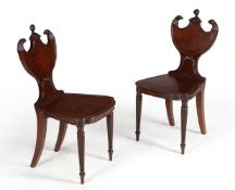 A pair of Regency mahogany hall chairs, circa 1815