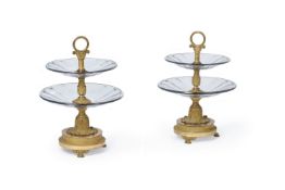 A pair of Empire gilt bronze and moulded glass etageres, circa 1820