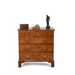 A George I walnut and feather banded chest of drawers, circa 1720