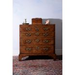 A George I walnut and feather banded chest of drawers, circa 1720