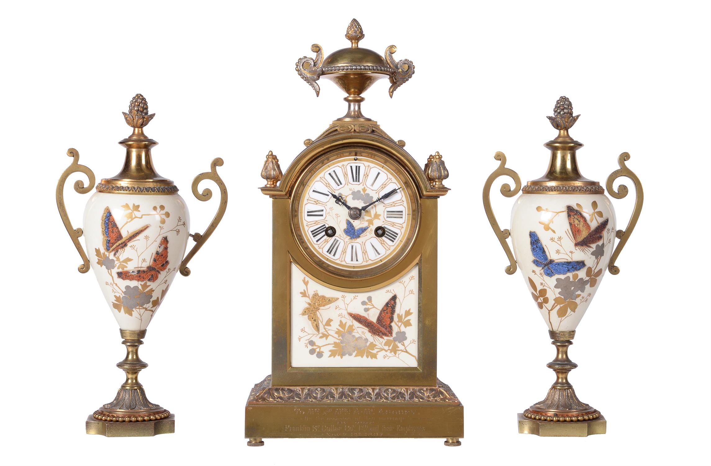 A gilt and porcelain mantel clock garniture with glass bead highlights...