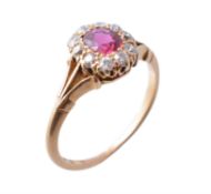 An early 20th century 18 carat gold ruby and diamond cluster ring