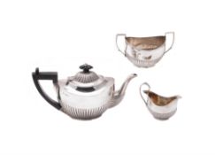 An Edwardian silver oval half gadrooned tea pot and sugar basin by Robert Pringle & Sons