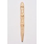A gold coloured bamboo propelling pencil by T. & Son