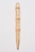 A gold coloured bamboo propelling pencil by T. & Son