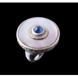 A mother of pearl and sapphire dress ring