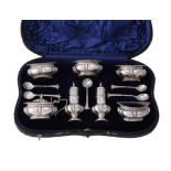 An Edwardian cased silver lobed baluster cruet set by S. W. Smith & Co.