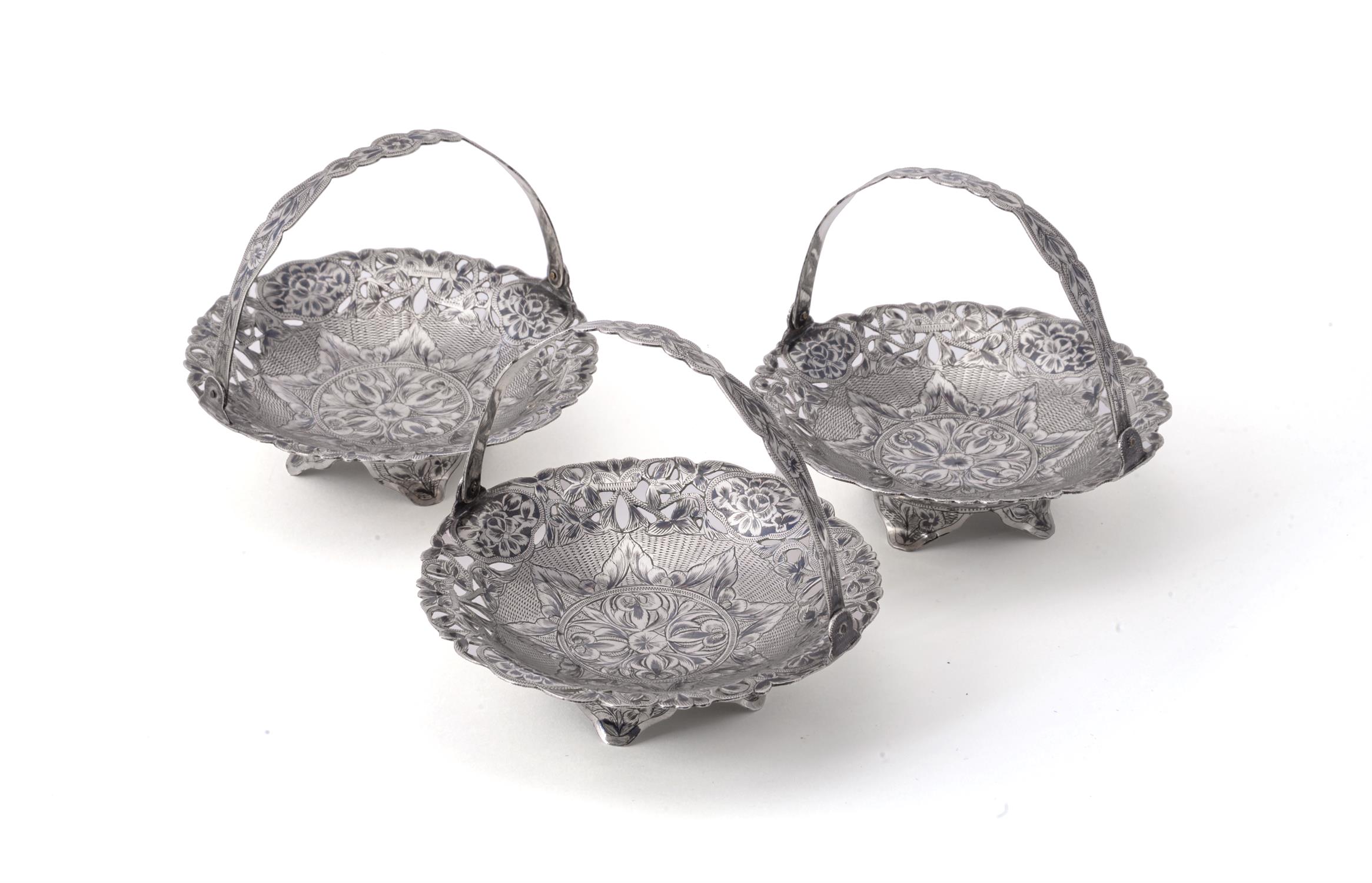 A set of three graduated silver and niello sweet baskets