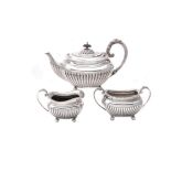 A silver three piece oblong tea set by James Dixon & Son