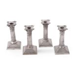 Four late Victorian silver Corinthian candlesticks by William Hutton & Sons Ltd.