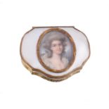 A gilt metal and mother of pearl cartouche shape snuff box