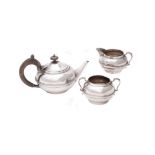 A silver three piece compressed circular tea set by Charles Boyton & Son Ltd.