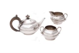 A silver three piece compressed circular tea set by Charles Boyton & Son Ltd.