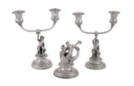 A matched pair of mid 19th century Italian (Papal States) silver coloured candelabra