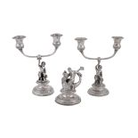 A matched pair of mid 19th century Italian (Papal States) silver coloured candelabra