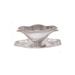 A French silver coloured shaped oval sauce boat on integral stand