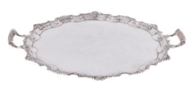 A silver shaped circular twin handled tray by Mappin & Webb