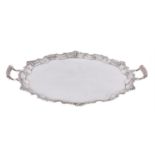A silver shaped circular twin handled tray by Mappin & Webb