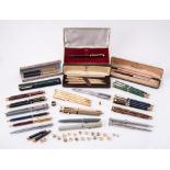 A collection of ball point pens, roller ball pens and propelling pencils