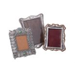 Three silver or silver coloured photograph frames