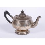 A silver circular tea pot by Walker & Hall