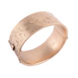 A 9 carat gold hinged bangle