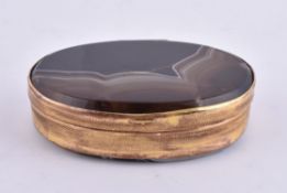 A gilt metal and banded agate oval box