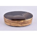 A gilt metal and banded agate oval box