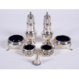 A pair of silver baluster pepperettes and cauldron salts by Crichton Brothers