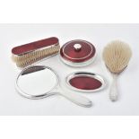 A matched silver mounted and red guilloche enamel dressing table set by Adie Brothers Ltd.