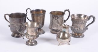 A collection of silver beakers