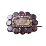 A 19th century garnet and hairwork brooch