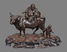 A Large Japanese Bronze Group of Hotei seated on the back of an ox