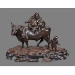 A Large Japanese Bronze Group of Hotei seated on the back of an ox