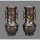 A Pair of Japanese Bronze Vases each with a rounded body on a slightly splayed foot