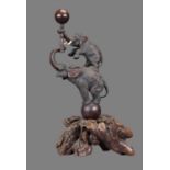 A Japanese Bronze Group of an Elephant Balanced on a Ball