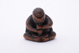 A Wood Netsuke carved in the form of a Tengu