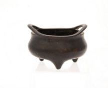 A Chinese bronze tripod censer