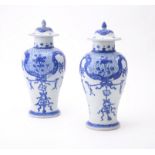 A pair of Chinese 'Shipwreck' blue and white vases and covers